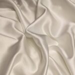 white textile on brown wooden table
